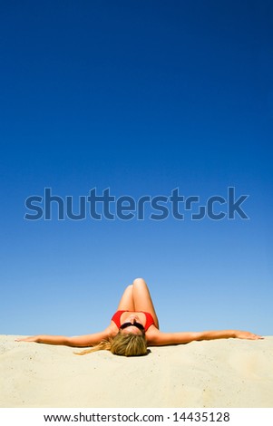 Creative image of sunbathing woman on the background of sky