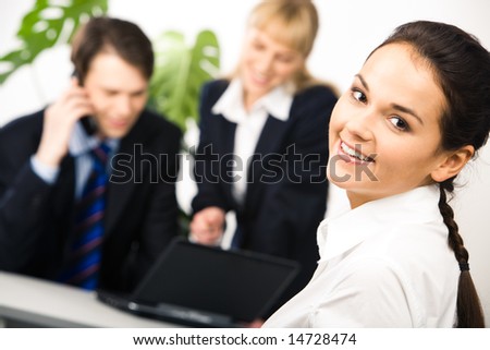 Photo of smart cheerful business lady on background of people looking at laptop monitor