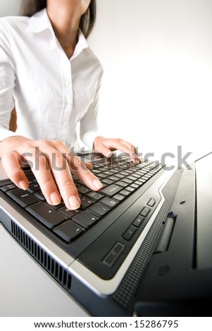 Photo of executive businesswomanâ??s hands on keyboard of laptop while typing documents