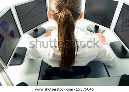 Photo of back of specialist doing something computer work