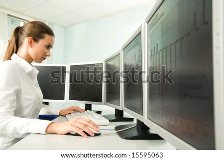 Portrait of serious businesswoman working in environment of computers