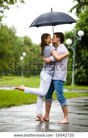 couple kissing in rain. the road in rain and going