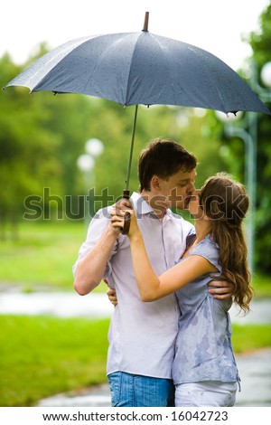 couple kissing in the rain. romantic couple embracing