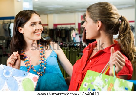 Portrait of two stylish women looking at each other at meeting in shop