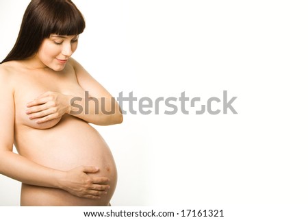 stock photo Photo of naked pregnant woman standing aside and looking at