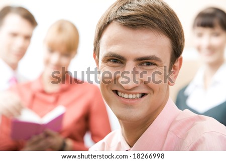 Handsome man looking at camera in working environment