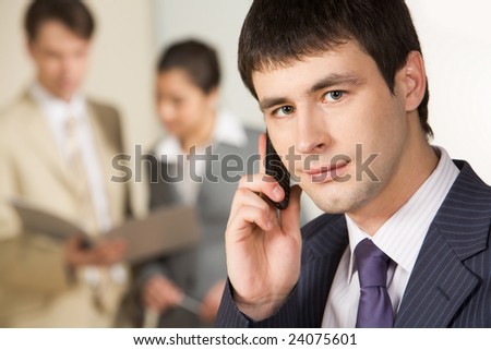 Portrait of successful businessman calling on mobile phone