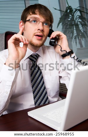 Photo of smart business leader explaining something on the phone and pointing his forefinger upwards
