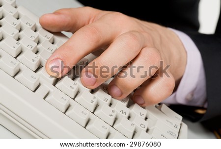 Image of human fingers on keyboard buttons during computer work
