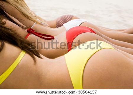 stock-photo-image-of-several-feminine-bottoms-in-bikini-sunbathing-on-the-beach-30504157.jpg