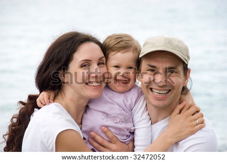 Portrait of happy family smiling at camera while on summer vacations