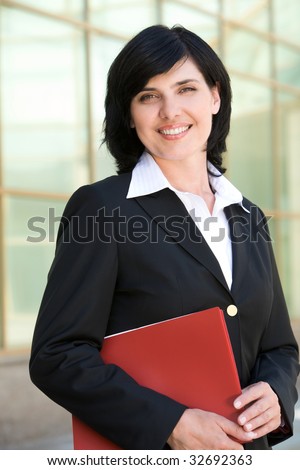 Image of pretty businesswoman looking at camera with happy smile