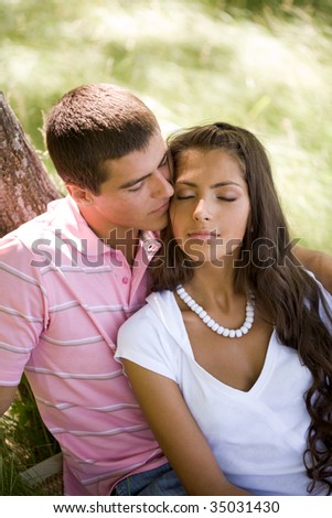 stock photo Image of tender man kissing girls face while spending time