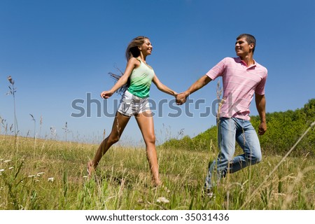 Photo of young man and woman taking walk in natural environment