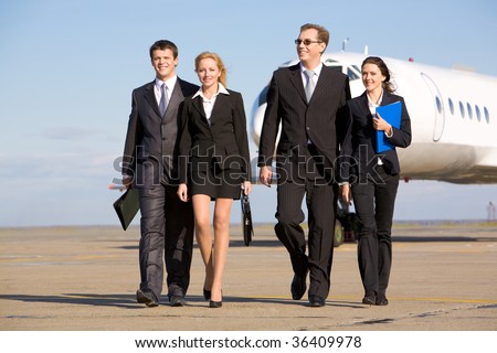 stock photo Group of successful people walking on the background of the