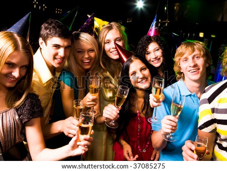 Portrait of glad people in smart clothing with champagne at birthday party