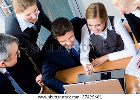 Above view of successful employees interacting with each other at meeting in office