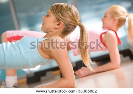 Image of sporty girl doing physical exercise on elbows