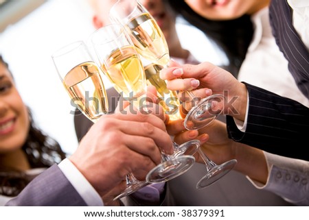 Close-up of friends hands holding glasses with champagne and making cheers