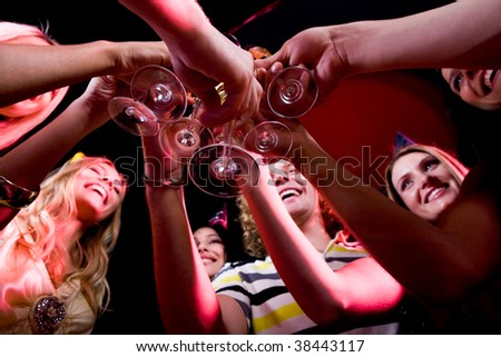 Bottom view of many friends touching glasses with each other