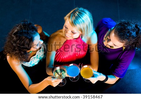 Above angle of happy girls cheering up at party