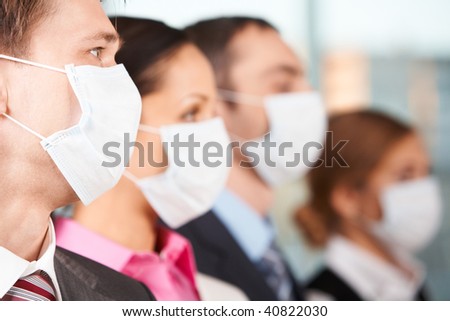 Portrait of businessman in protective mask with line of people on background