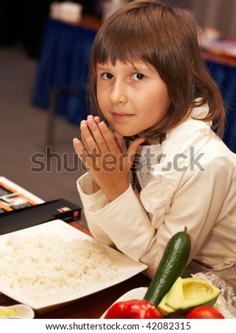 CHELYABINSK - NOVEMBER 17: Teenage girl with her hands put together by mouth at sushi preparing master class, November 17, 2009 in Holiday Inn Chelyabinsk-Riverside 4*, Chelyabinsk, Russia.