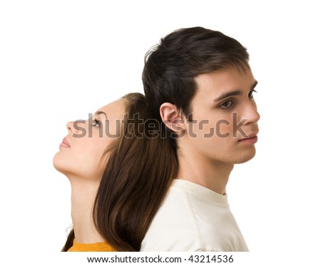 Photo of handsome guy and his girlfriend standing back to back