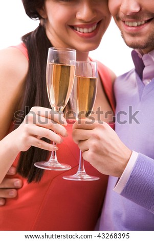 Portrait of happy couple with champagne flutes celebrating holiday