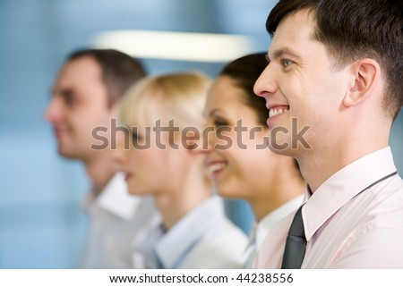 Image of business group standing in line with handsome leader in front