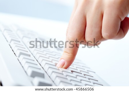 Image of human forefinger on keyboard button