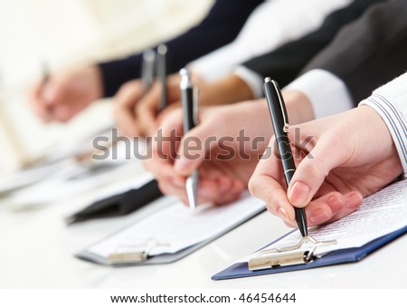 Close-up of business person hand working with document