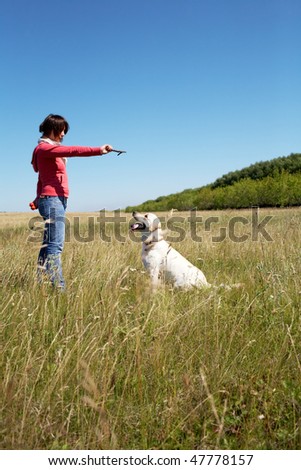 Photo of woman training her dog