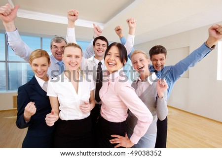 Portrait of successful people raising hands showing gladness