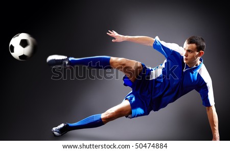 Image of soccer player doing flying kick with ball