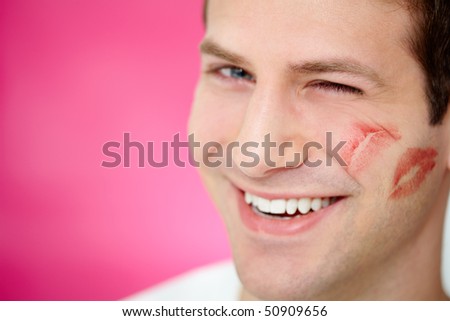 stock-photo-handsome-man-with-print-of-lipstick-on-his-cheek-winking-at-camera-50909656.jpg