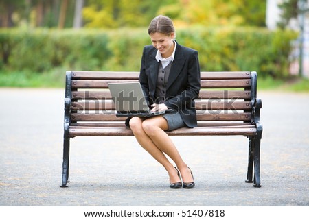 Image of elegant employer sitting on the bench
