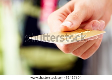 Close-up of credit card in human hand in the shop