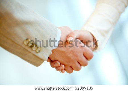 Handshake of business partners after signing contract