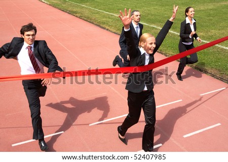 Photo of happy businesswoman crossing finish line during race