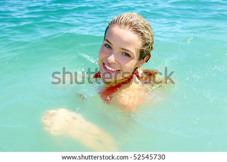 Photo of pretty young woman swimming in the lake