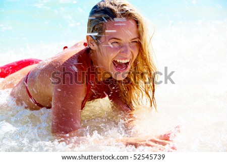 Beautiful woman having a fun while swimming in the lake