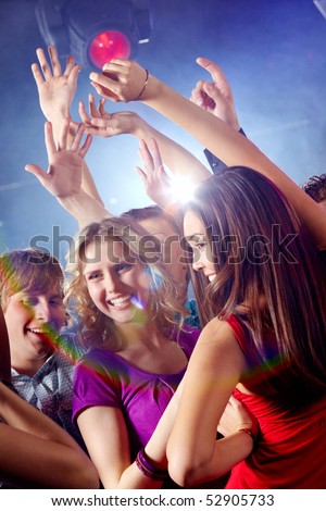 Image of pretty girls dancing with their boyfriends in night club