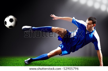Image of soccer player doing flying kick with ball on football field Image of soccer player doing flying kick with ball on football field