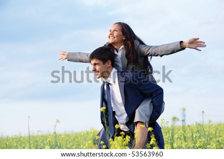 Portrait of happy business partners enjoying life and freedom in meadow
