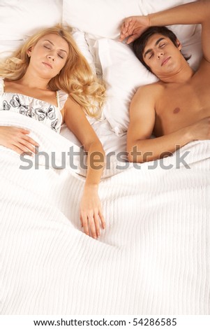Photo of serene woman and man lying in bed and sleeping