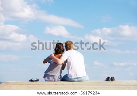 Image of guy embracing his girlfriend while enjoying hot summer day