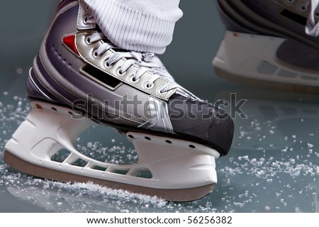 Close-up of skates on player feet during ice hockey