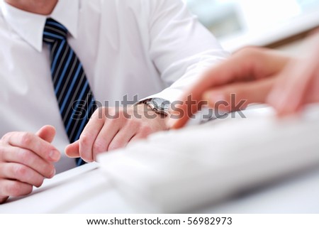 Close-up of male hands with typing secretary hands in front of him
