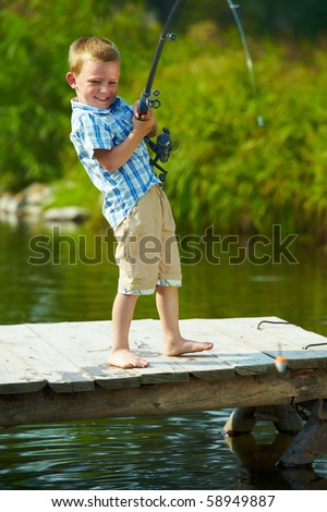 Photo of little kid pulling rod while fishing on weekend